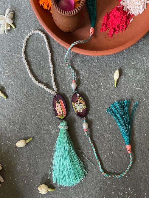 emerald green light and indigo stone cotton thread rakhi - 20087983 - Very Small Image - 1