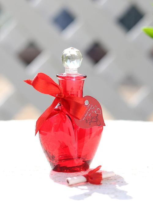 red small bottle,red ribbon,artificial rose petals,heart shape small tag - 15941906 - Very Small Image - 1