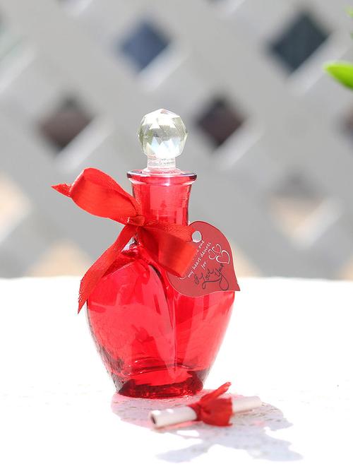 red small bottle,red ribbon,artificial rose petals,heart shape small tag - 15941908 - Very Small Image - 1
