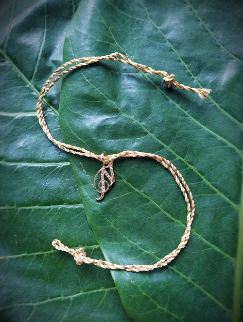 yellow gold plated thread rakhi - 17892442 - Very Small Image - 1